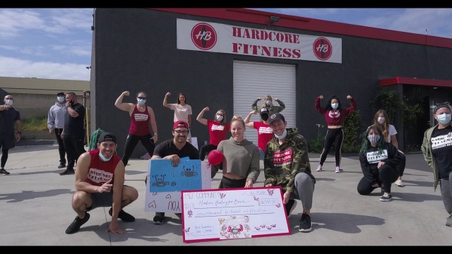 'hardcore fitness hb charity event - getting the check'